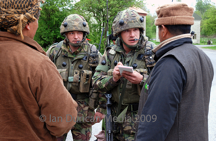 COMMUNICATION... Sgt Stephen McConnell from Barrowcliff meets the locals in Imber village during a foot patrol...