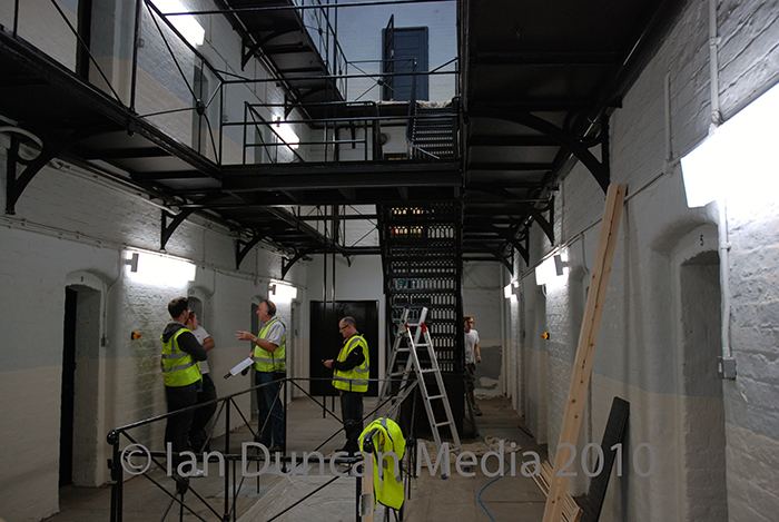 WORK IN PROGRESS... Members of the film’s art department transforming the inside of Dean Road prison into a film set...