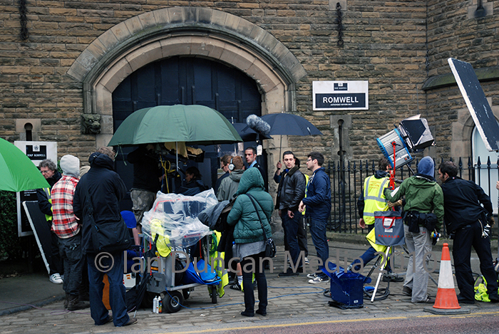 ON SET... Director Reg Traviss, centre, outside Dean Road gaol in Scarborough which doubled as HMP Romwell in the film Screwed...