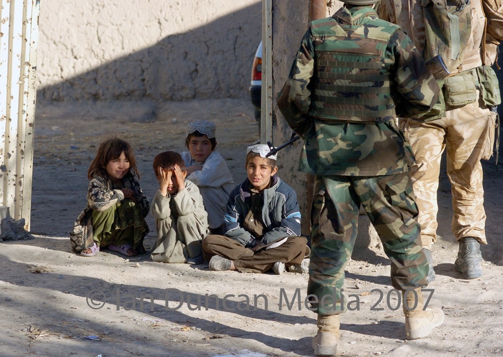 FOOT PATROL... Troops pass local kids in Masa Qala in Helmand province, Afghanistan...