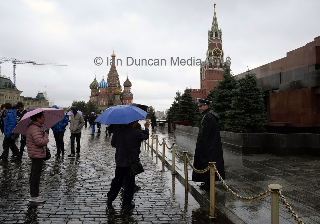 RED SQUARE... Tourists chat to a guard outside Lenin's mausoleum in Moscow, Russia...