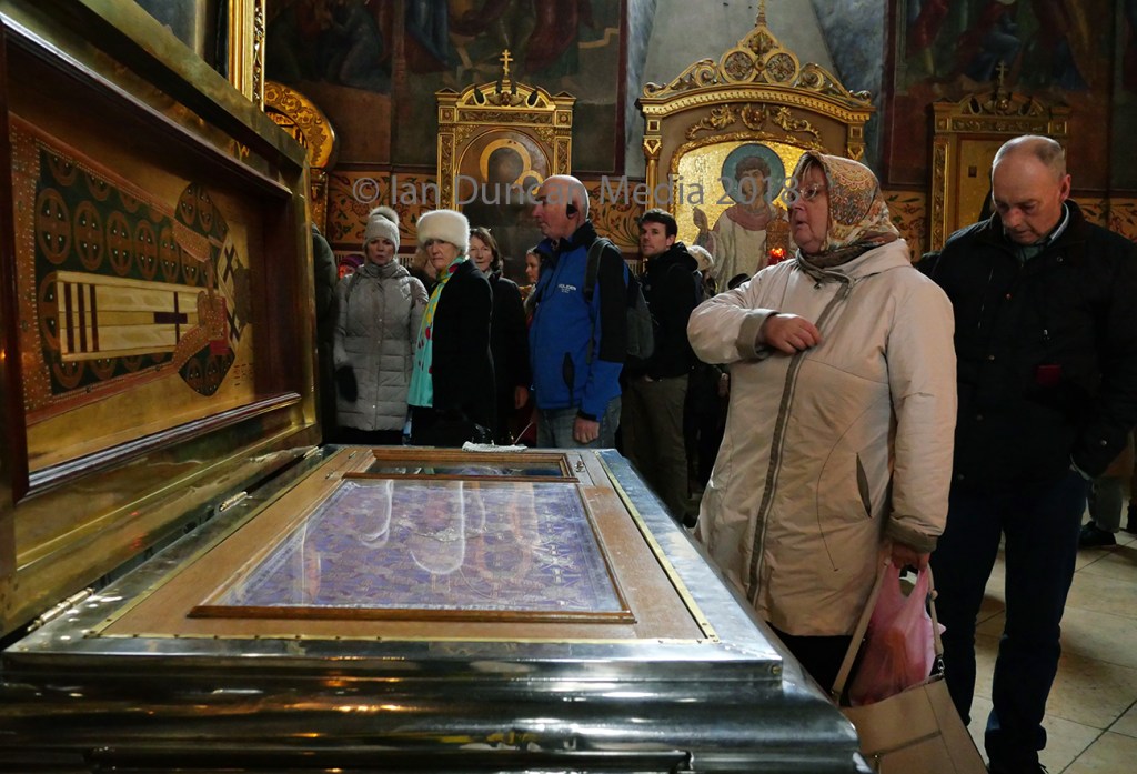 PRAYING... A woman by a tomb inside the Assumption Cathedral at Sergiev Posad...