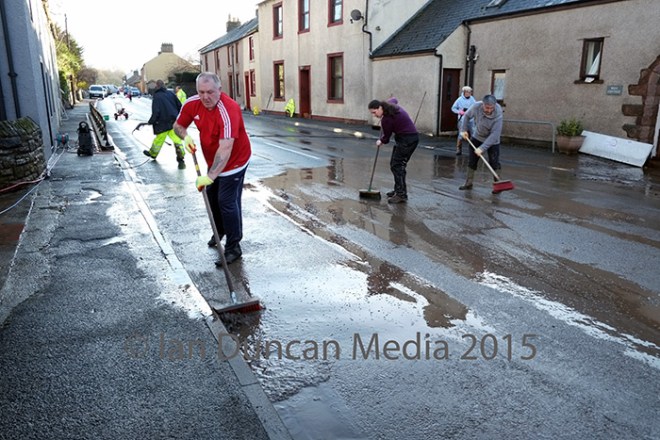 AFTERMATH... Residents in Eamont Bridge clear up the mess after Storm Desmond hit Cumbria in December 2015...