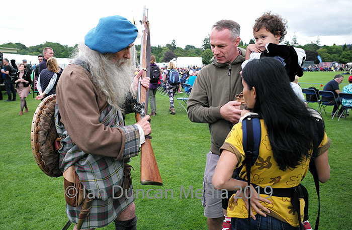 DEMONSTRATION... A Jacobite reenactor shows visitors his replica musket at the Inverness Highland Games... 