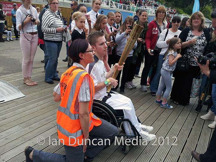 RELAY... Crowds gather around the Olympic torch...