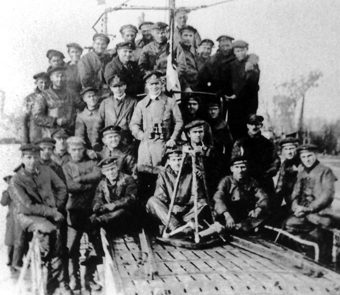 U-BOAT CREW... Around the submarine's conning tower...