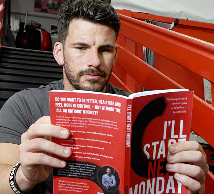 AUTHOR... Dan Moore skimming through his new book which he has self-published...