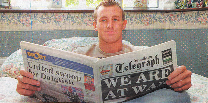 OLD NEWS... Marine Mark Stow catches up on the news with the Scunthorpe Telegraph after coming home from serving in Iraq with 40 Commando. Mark read our special war breakfast edition from the first morning of the conflict...