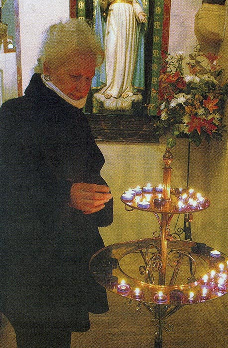 TRIBUTE: Margaret Lampkowska lights a candle to mark the death of Pope John Paul at Holy Souls Church, Scunthorpe...