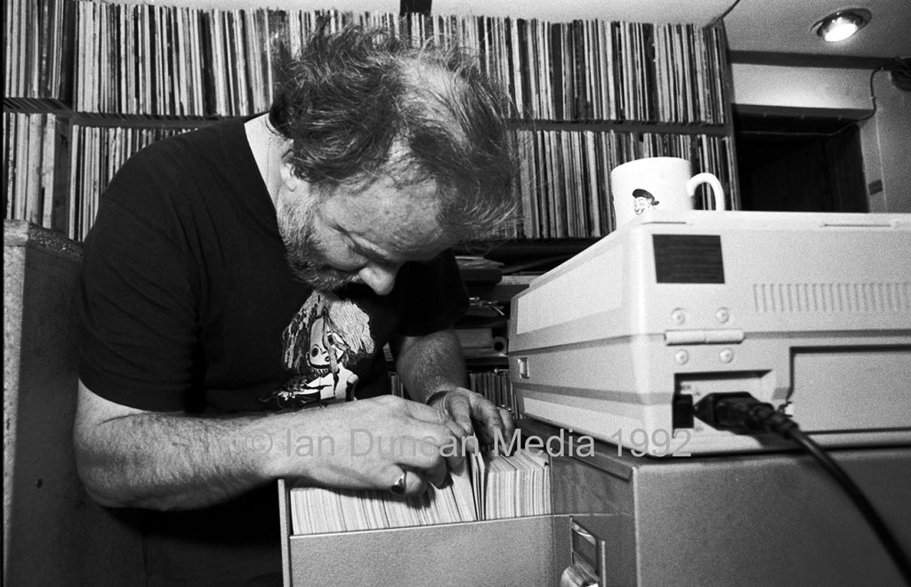 JOHN PEEL... Looking through his card index in his music library at his Stowmarket home...