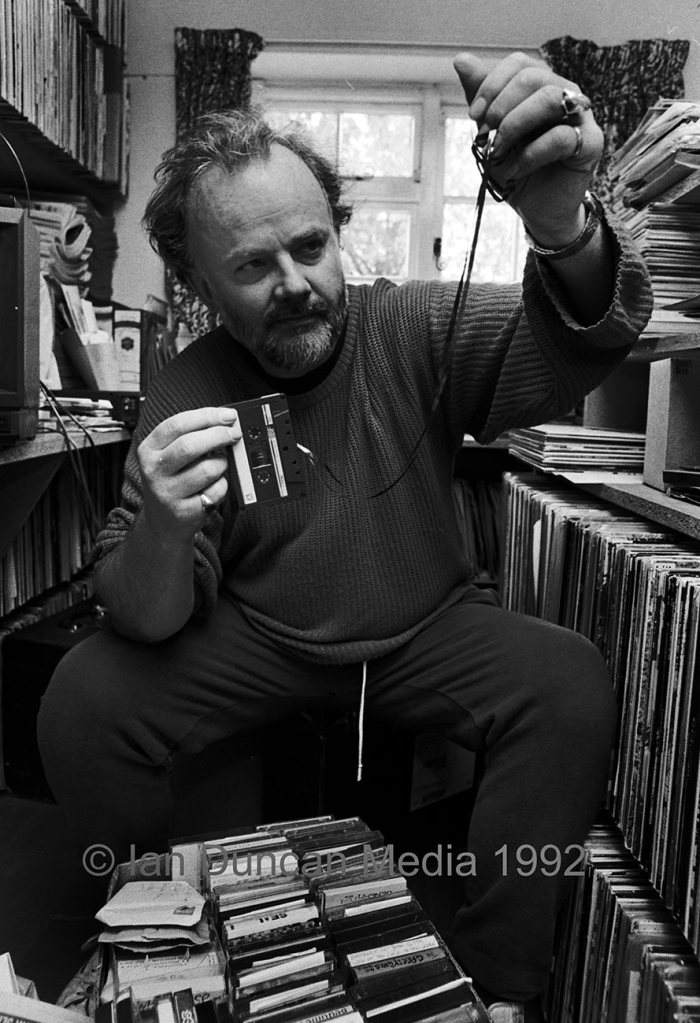 JOHN PEEL... In his music library at his Stowmarket home... I must clarify that this was my cassette and not a demo tape...