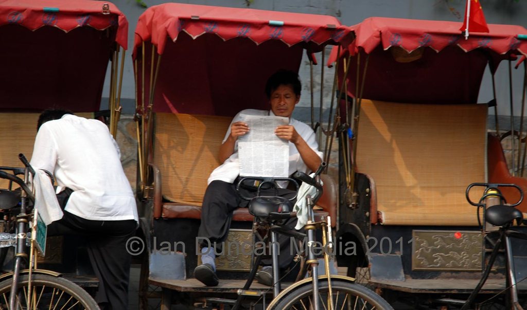 RICKSHAW RIDE… A driver takes a break as we pass by in Beijing in China…