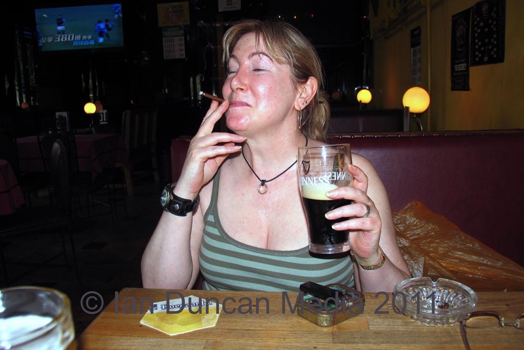 SMOKING IN PUBS... Karen Duncan in The Den Bar in Beijing in China where there is no smoking ban...