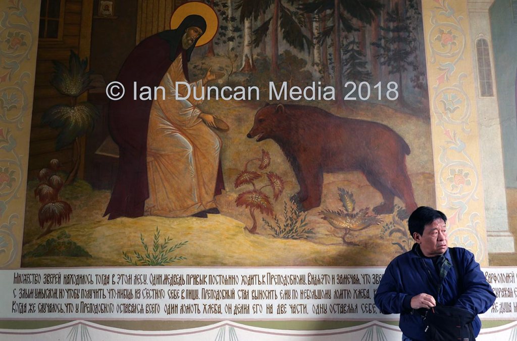 MOSCOW... A visitor by a religious icon at a monastery in Sergiyev Posad...