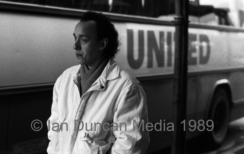 DARLINGTON BOUND... Ken Lambell at a bus station during our trip south...