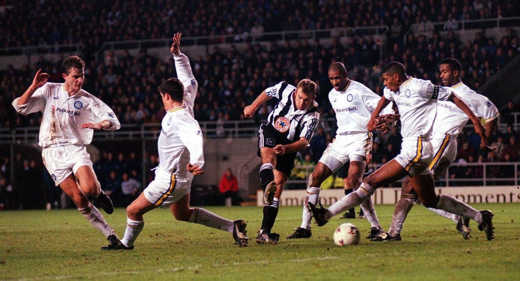 CLINCHER... Alan Shearer drills his, and Newcastle's, second goal through a crowd of Leeds players at St James's Park yesterday...