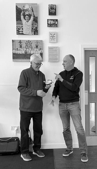 PRESENTATION... Club president John MacRitchie with Hugh D MacLennan at the Lovat Shinty Memories session...