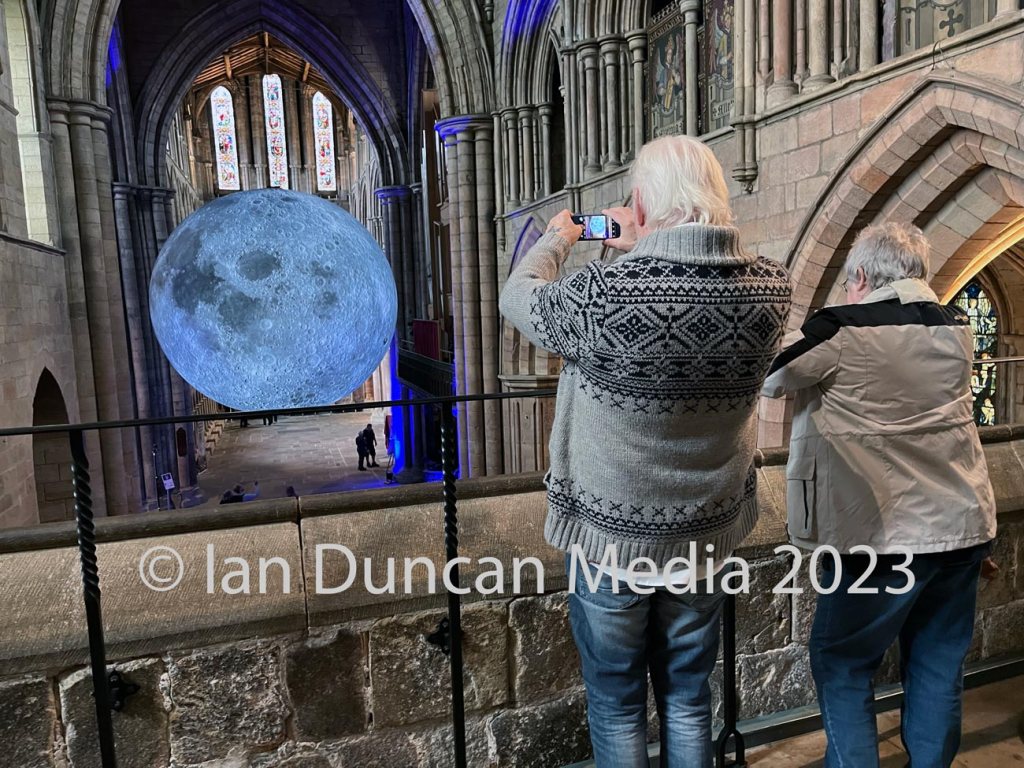 MUSEUM OF THE MOON... Visitors snap a shot of artist Luke Jerram's installation at Hexham Abbey which is due to run until November...