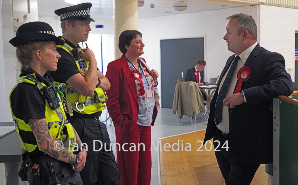 THE NEXT COMMISSIONER... Labour candidate David Allen chats to officers on duty at Whitehaven Sports Centre during the the election count for the next Cumbrian police, fire and crime commissioner...