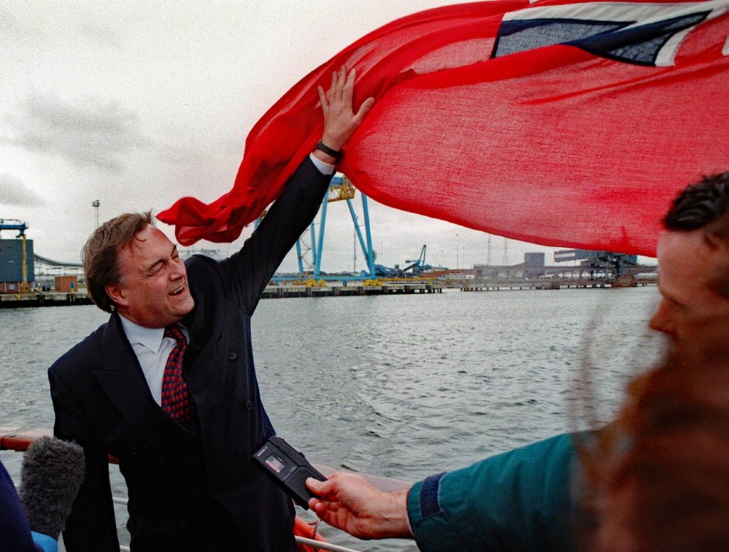 RED FLAG... Labour's deputy PM John Prescott battles with the Red Ensign while aboard the cruiser Island Scene on the River Tyne during a visit to the north east in October 1997...