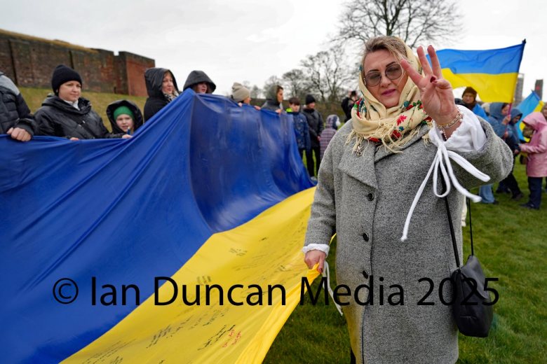 ANNIVERSARY... Woman raises three fingers during a march to commemorate the third anniversary of Russia's invasion of Ukraine by Carlisle Castle following a march from Carlisle Cathedral...