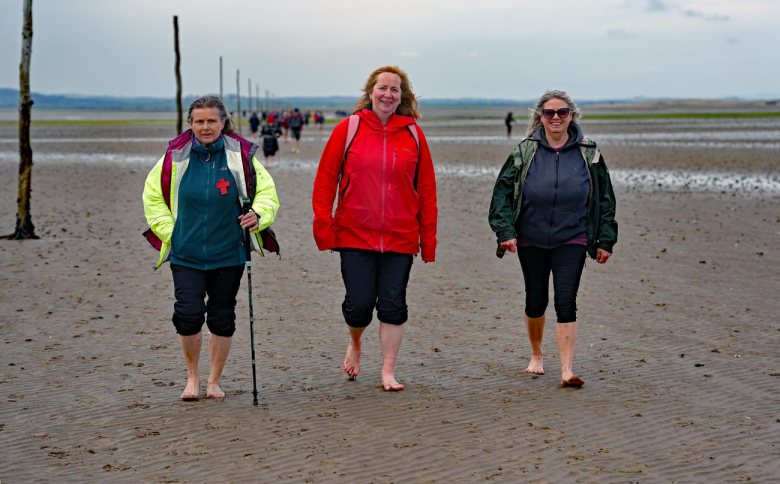 PILGRIMS' PROGRESS... Members of the annual Northern Cross pilgrimage arrive at the island of Lindisfarne after a week of trekking across the north of England...