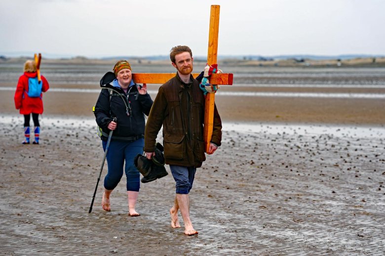 PILGRIMS' PROGRESS... Members of the annual Northern Cross pilgrimage arrive at the island of Lindisfarne after a week of trekking across the north of England...