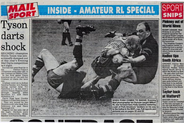 WHEN PUSH COMES TO SHOVE... Evening Mail photographer lan Duncan caught Millom RL star forward Gary Kelly (centre) clattering a pair of Park Amateurs' tacklers on his way to the tryline in the BNFL cup. From the North West Evening Mail on February 21, 1996.
