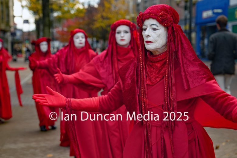 The Red Rebels, who are normally associated with Extinction Rebellion, perform in Carlisle to support the regular weekly vigil for Gaza and Palestine and raw a Red Line for Gaza following the recent peace deal. Picture: Ian Duncan.