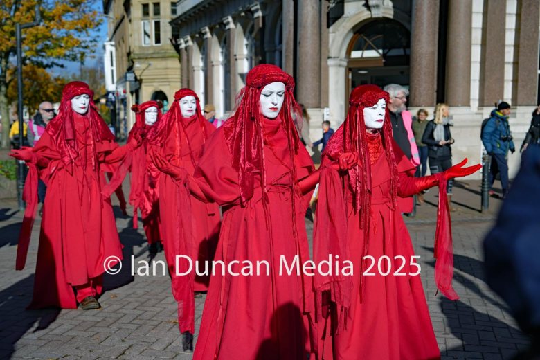 The Red Rebels, who are normally associated with Extinction Rebellion, perform in Carlisle to support the regular weekly vigil for Gaza and Palestine and raw a Red Line for Gaza following the recent peace deal. Picture: Ian Duncan.