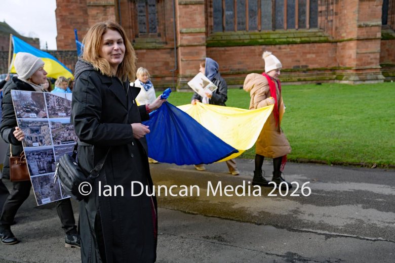 Alla Stoica heads from Carlisle Cathedral towards the Vigil for Ukraine in the city centre to mark the fourth anniversary of the Russian invasion of Ukraine. Picture: Ian Duncan.