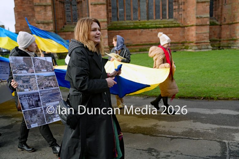 Alla Stoica heads from Carlisle Cathedral towards the Vigil for Ukraine in the city centre to mark the fourth anniversary of the Russian invasion of Ukraine. Picture: Ian Duncan.