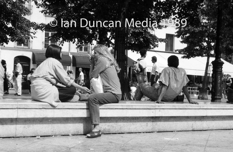 Two women catch up over a cigarette in Paris. Picture: Ian Duncan.