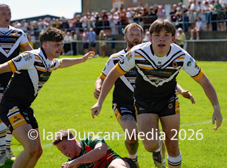 Natty Dougan celebrates after scoring his try for Wath Brow hornets, in white shirts, against West Bowling. Picture by Ian Duncan.