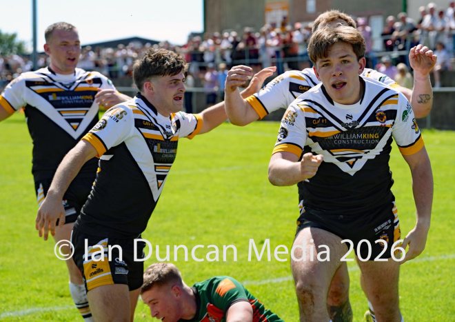 Natty Dougan celebrates after scoring his try for Wath Brow hornets, in white shirts, against West Bowling. Picture by Ian Duncan.