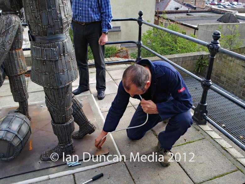 Artist Ray Lonsdale installs The Smuggler's Apprentice (Lesson 1) statue in Scarborough in North Yorkshire. Photo: Ian Duncan.